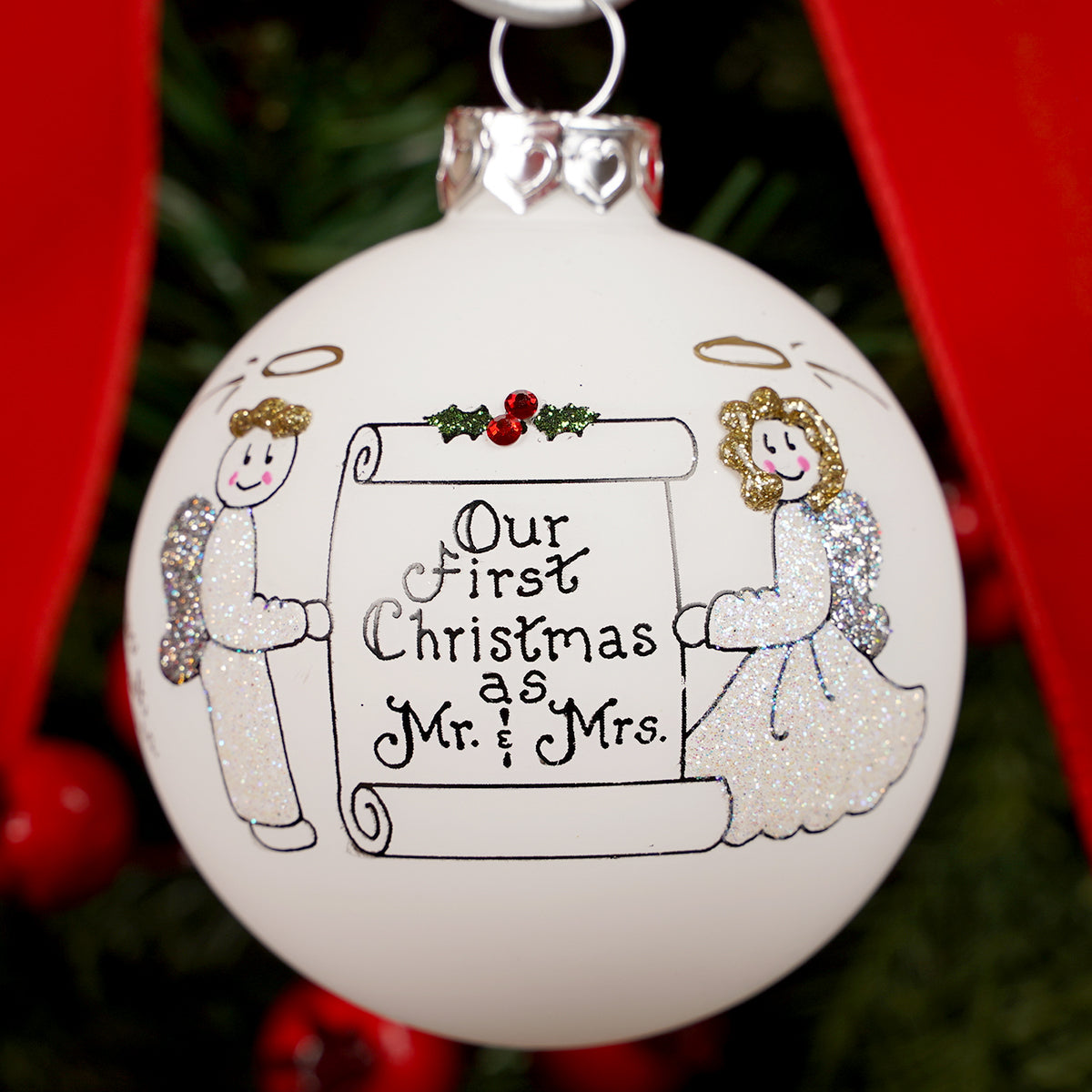 Christmas ornament with 'Our First Christmas as Mr. & Mrs.' text and angel figures.
