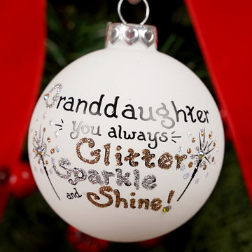 Decorative Christmas ornament with text 'Granddaughter you always Glitter Sparkle and Shine!' on a tree.