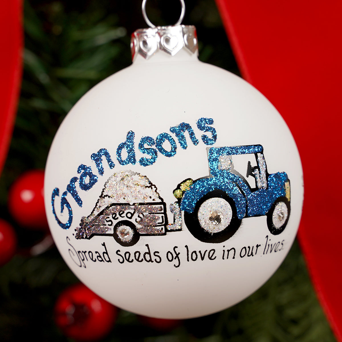 Decorative Christmas ornament with a blue tractor and text on a white background Grandson