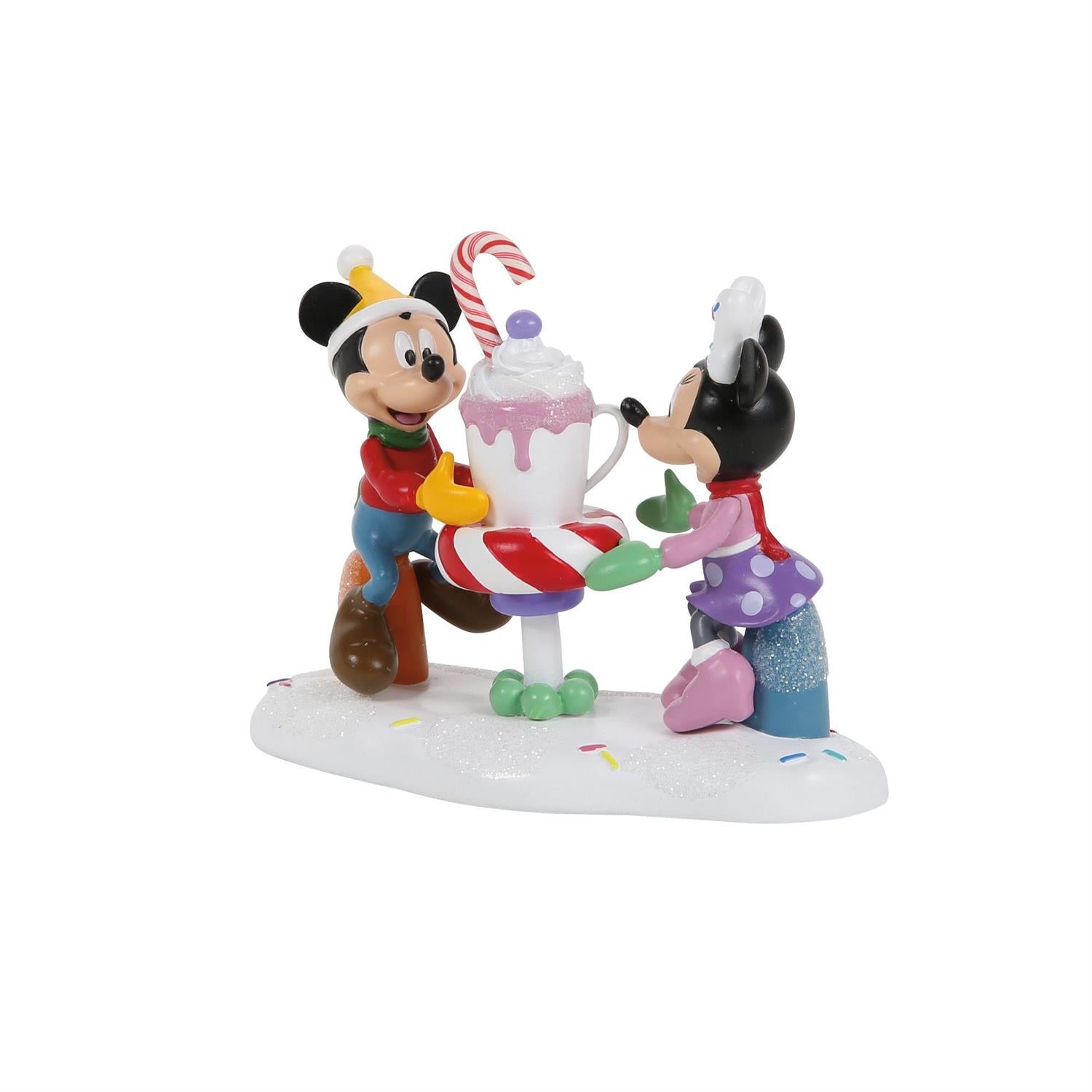 Figurine of Mickey and Minnie with a candy cane and a mug of cocoa on a white background