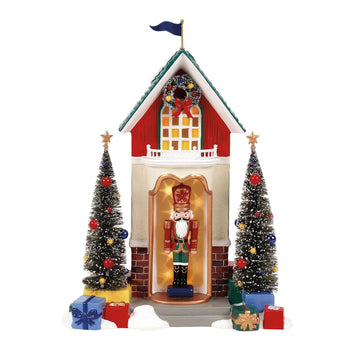 Decorative Christmas scene with a house, trees, and a nutcracker figure on a white background