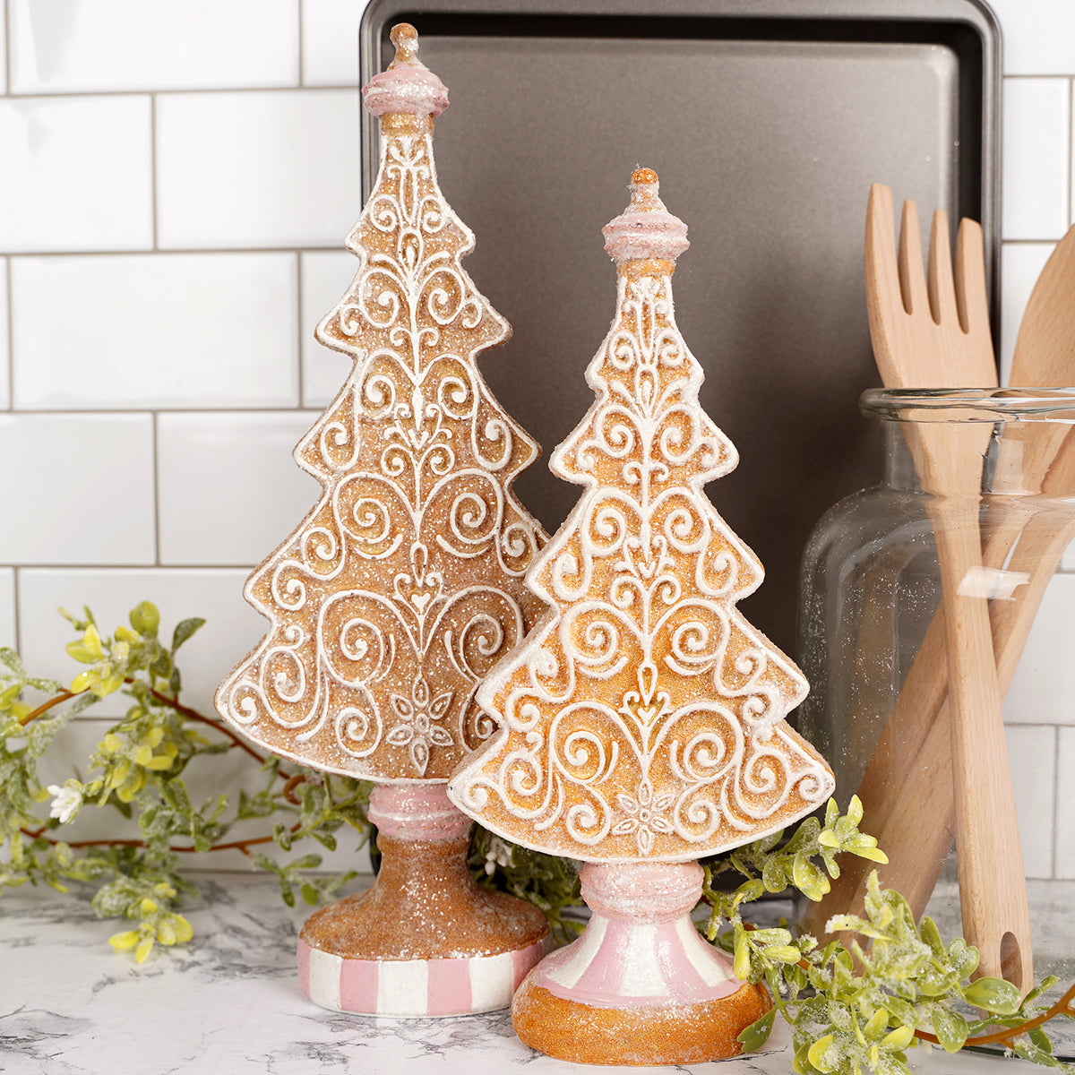 Decorative Christmas trees with intricate designs on a kitchen counter.