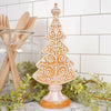 Decorative gingerbread tree on a stand with kitchen utensils and greenery in the background Christmas Place