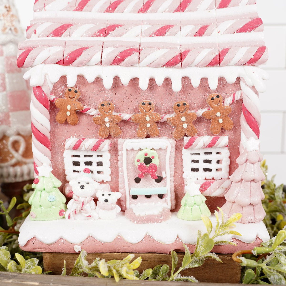 Gingerbread house with candy decorations on a white background