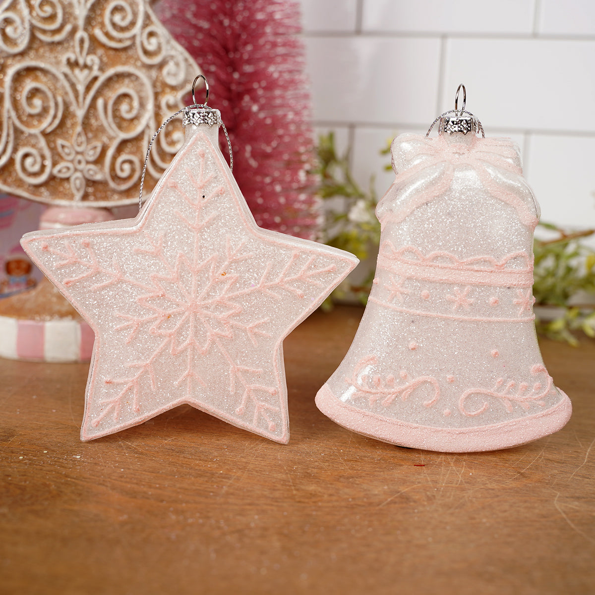 Decorative star and bell ornament on a wooden surface with a blurred background