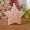 Star-shaped decorative ornament with snowflake pattern on a wooden surface