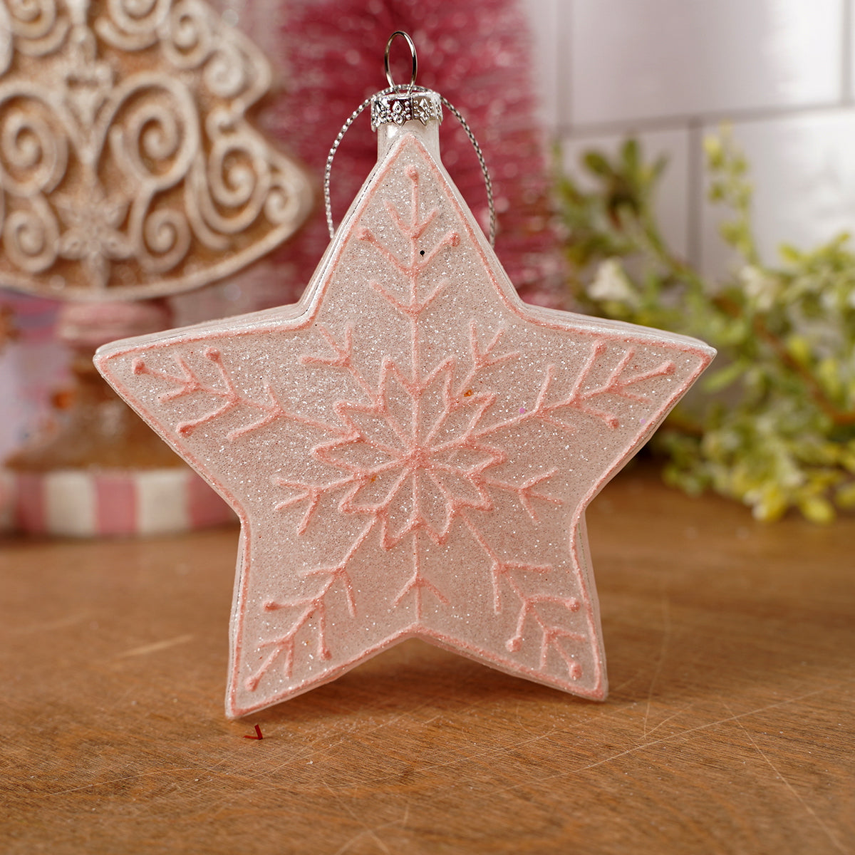 Star-shaped decorative ornament with snowflake pattern on a wooden surface